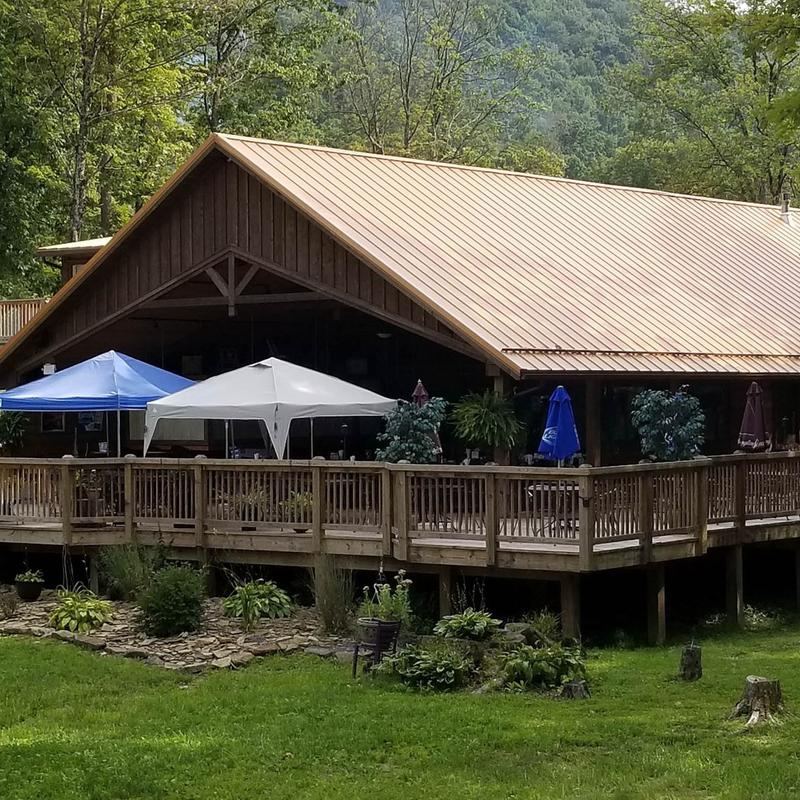 The cabin-style restaurant and its deck among the trees