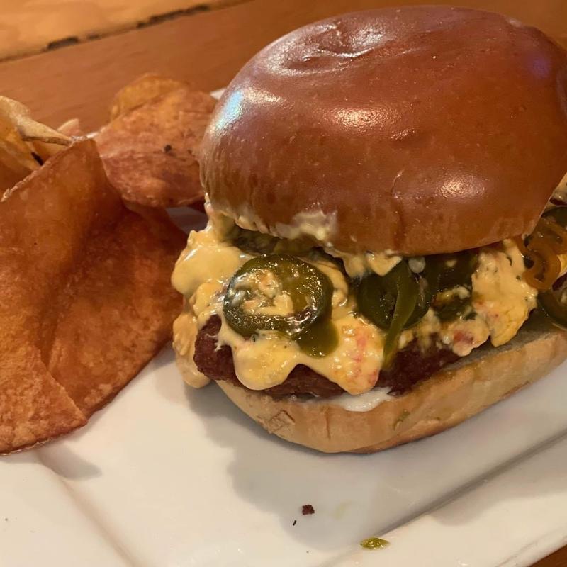 The Magooburger with pimento cheese and jalapeños, with house chips