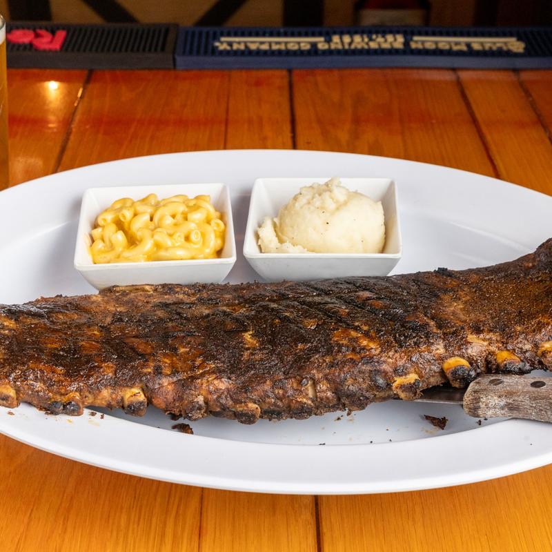 A full rack of dry-rubbed ribs with mac and cheese and mashed potatoes