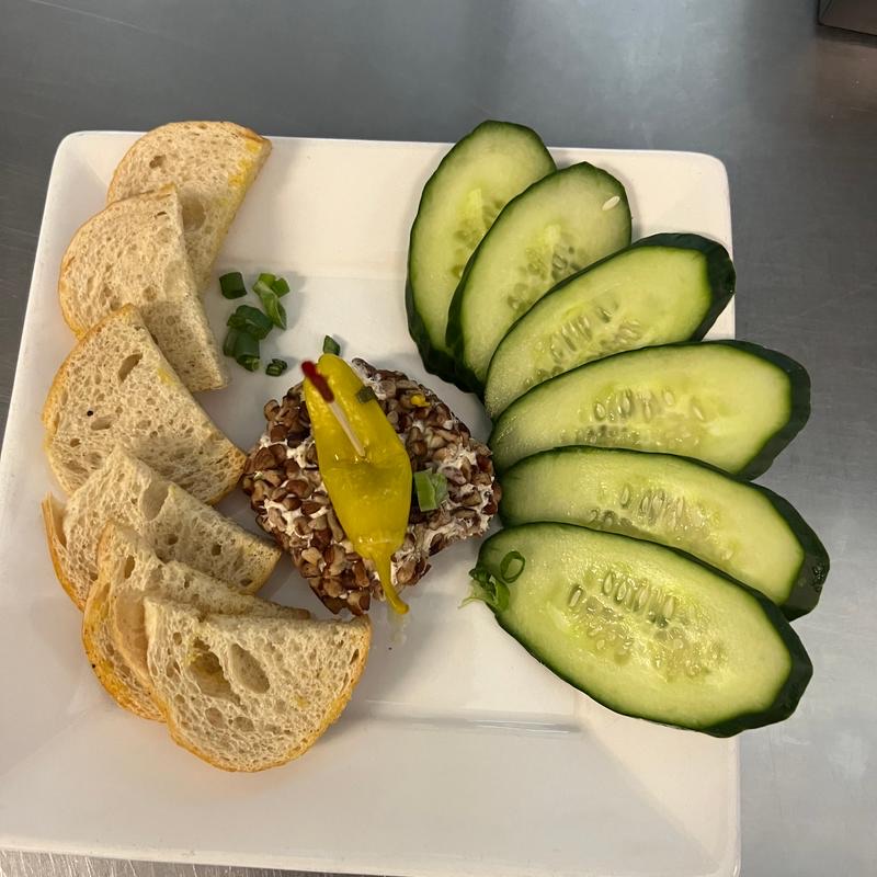 Smoked trout spread rolled in pecans, with bread and cucumber